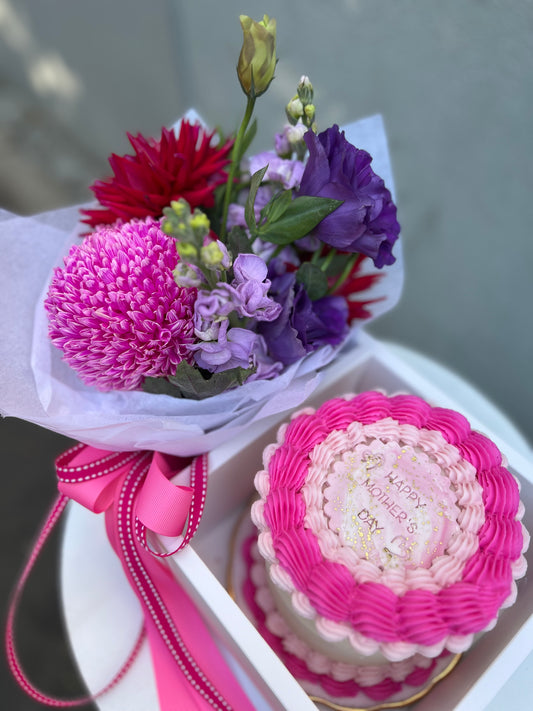 Posy of blooms and a decorated cake