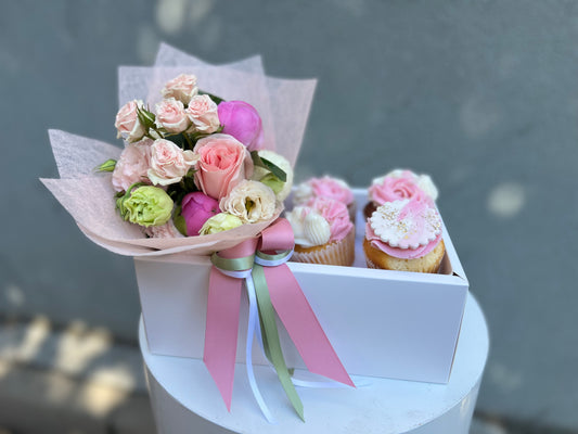 Posy of blooms and four decorated cupcakes
